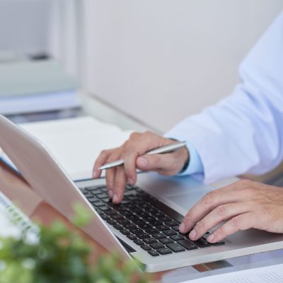 Professional doctor networking at the table at his office